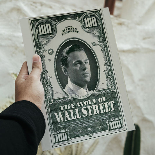 Close-up of a hand holding the printed Wolf of Wall Street Dollar Bill Poster, displaying the high-quality print and intricate currency details of the cinematic wall art.