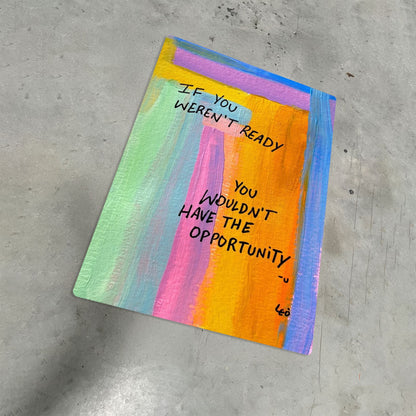 Abstract colorful motivational quote metal poster on a concrete floor highlighting the vibrant UV-printed finish.