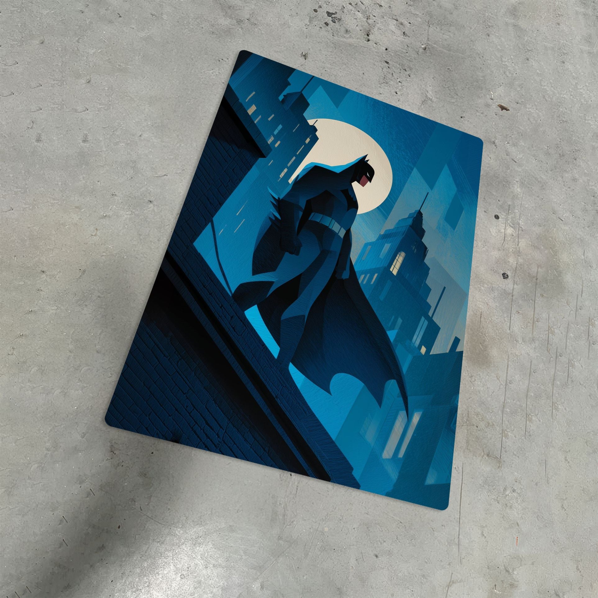 Minimalist metal poster of Batman overlooking Gotham City at night shown from a low-angle perspective on a concrete floor.