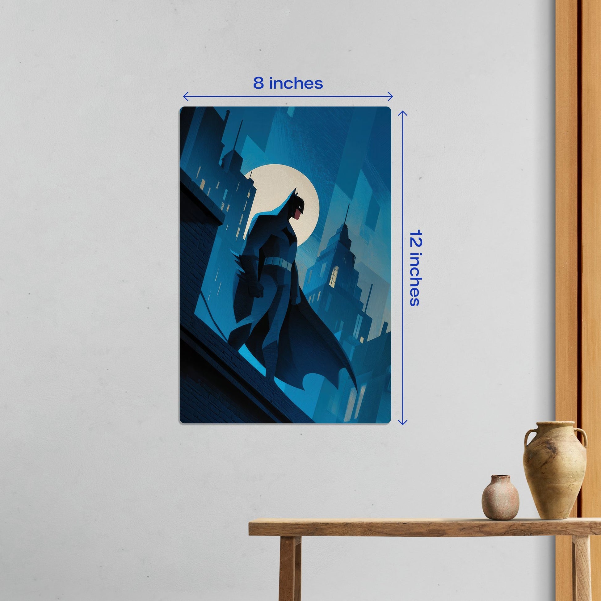 Small 8x12 inch Batman Gotham City minimalist metal poster shown on a wall for size reference in a home interior.