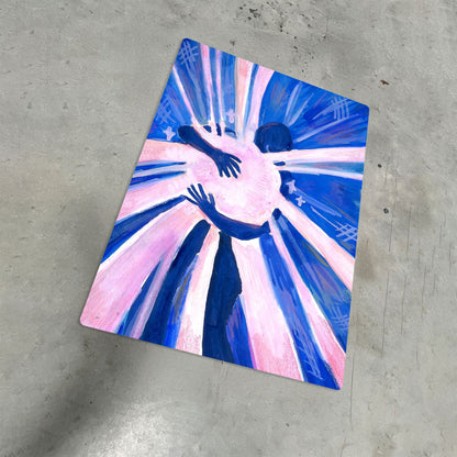 Abstract hug illustration on a metal poster featuring blue and pink tones on a concrete floor.