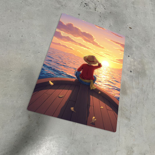 Luffy One Piece Sunset Metal Poster displayed at an angle on a textured concrete surface to showcase its slim durable build