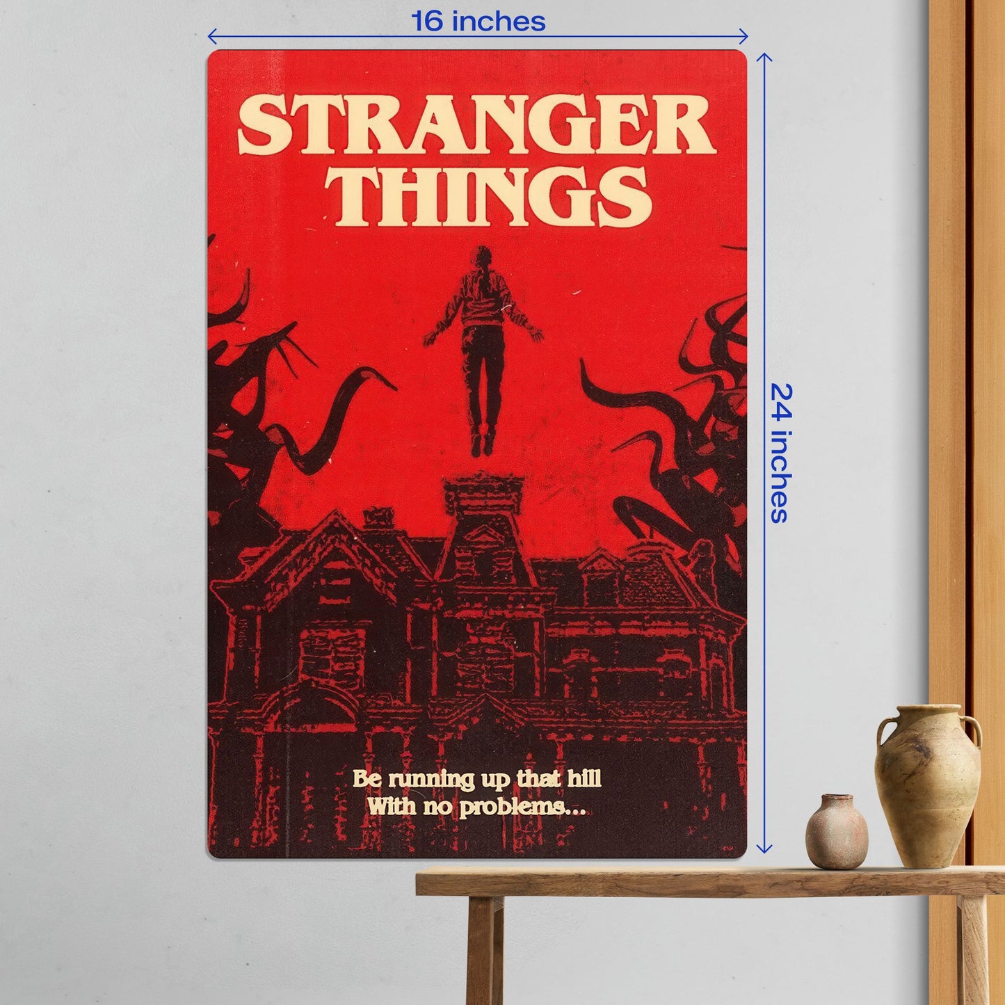 Large 16x24 inch Stranger Things Max Mayfield metal poster shown as premium wall decor above a wooden table.