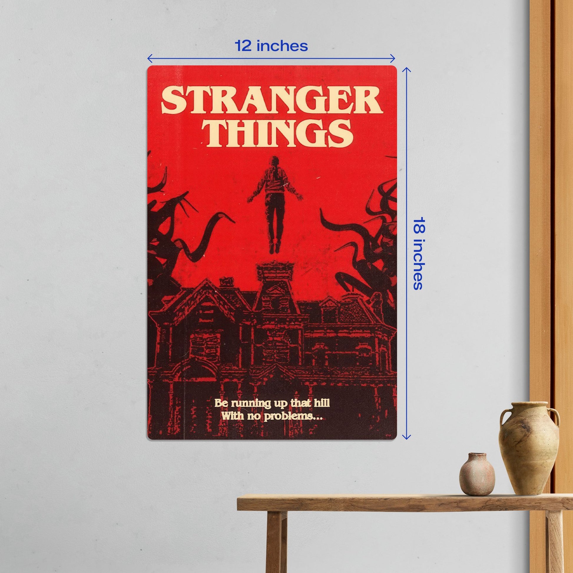 Medium 12x18 inch Stranger Things Max Mayfield metal poster centered on a white wall above a wooden console table.