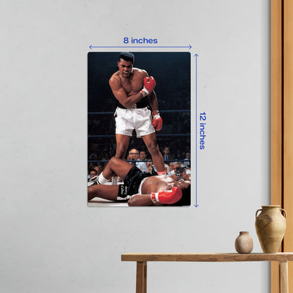 Small 8x12 inch Muhammad Ali iconic knockout metal wall art poster shown in a home office or living room setting.