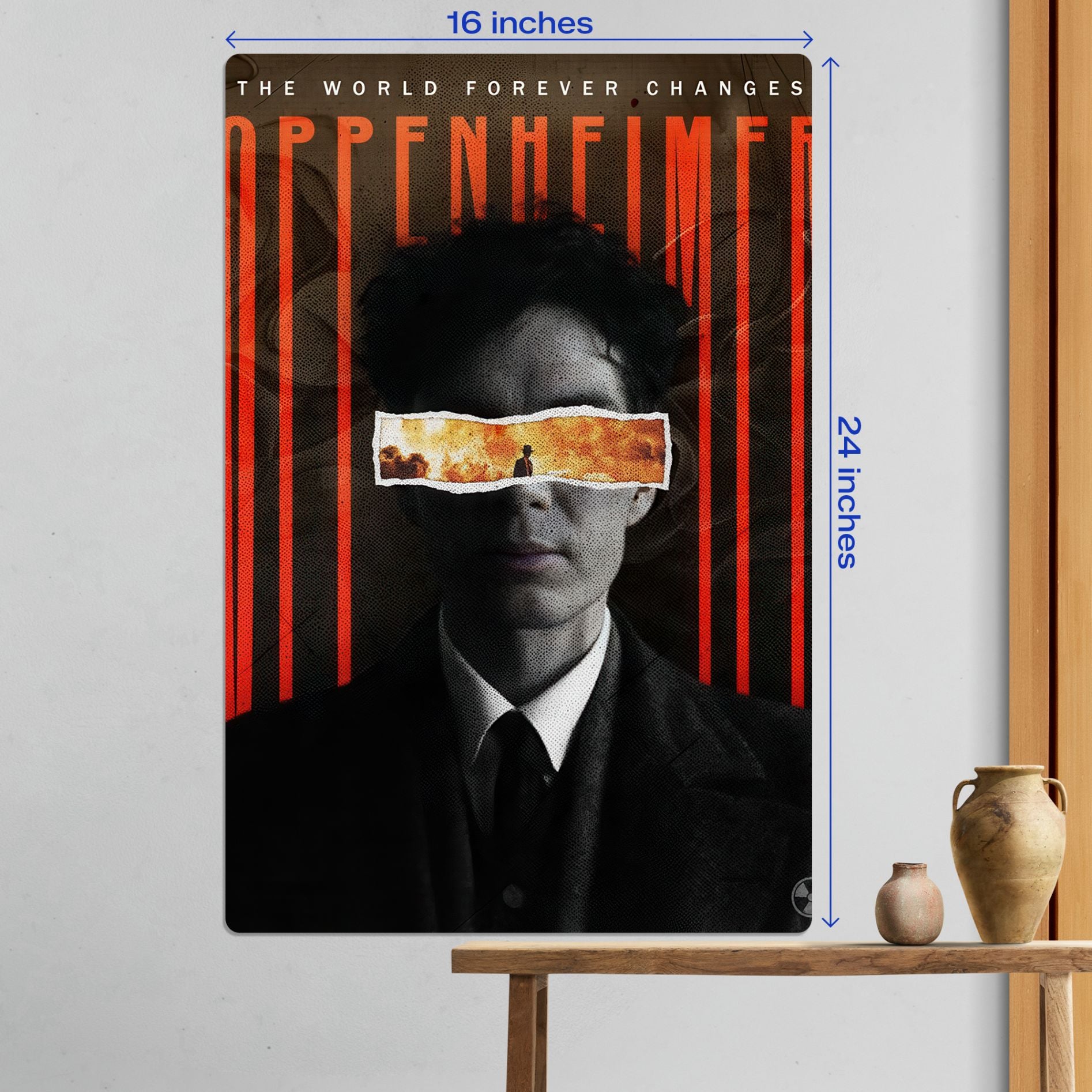 Large 16x24 inch Oppenheimer movie metal poster mounted on a wall in a living room setting above a wooden bench.
