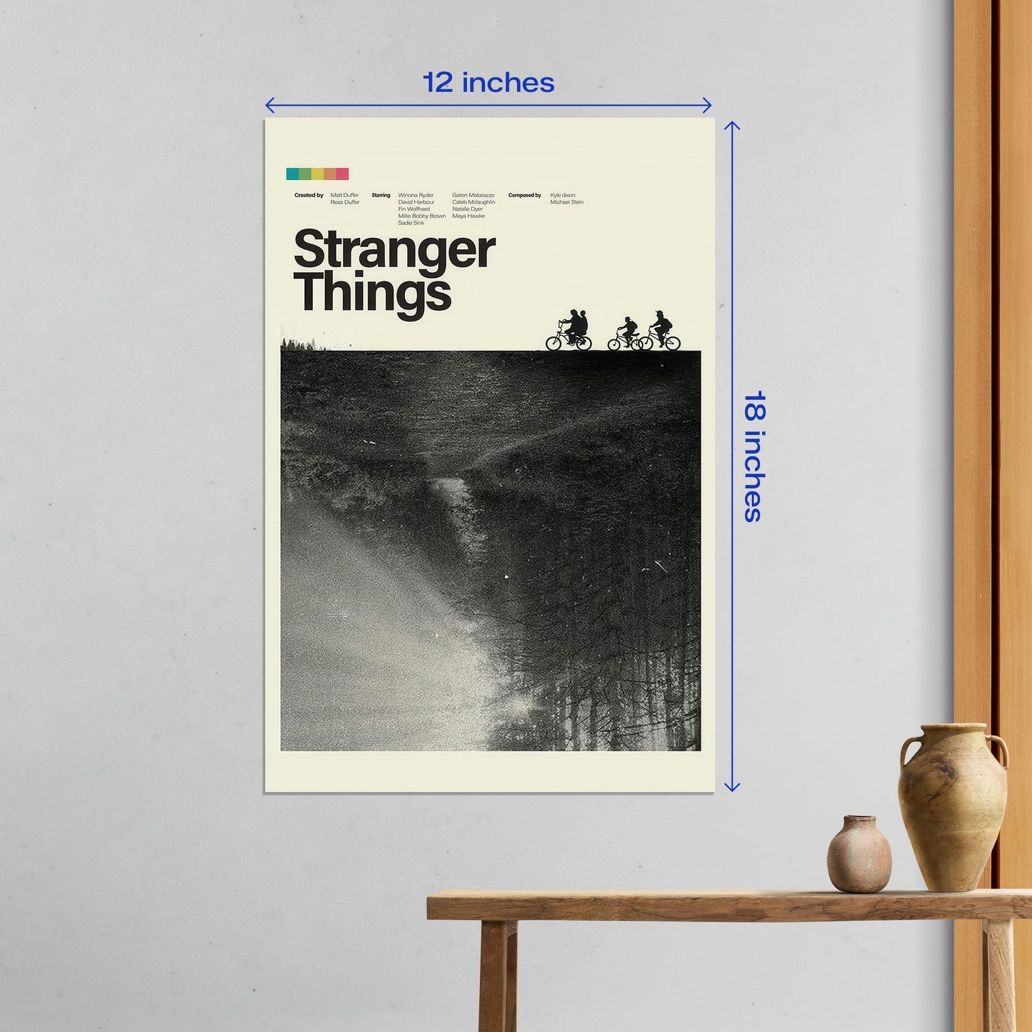Medium 12x18 inch Stranger Things metal poster displayed on a white wall featuring the iconic silhouette of kids on bicycles.