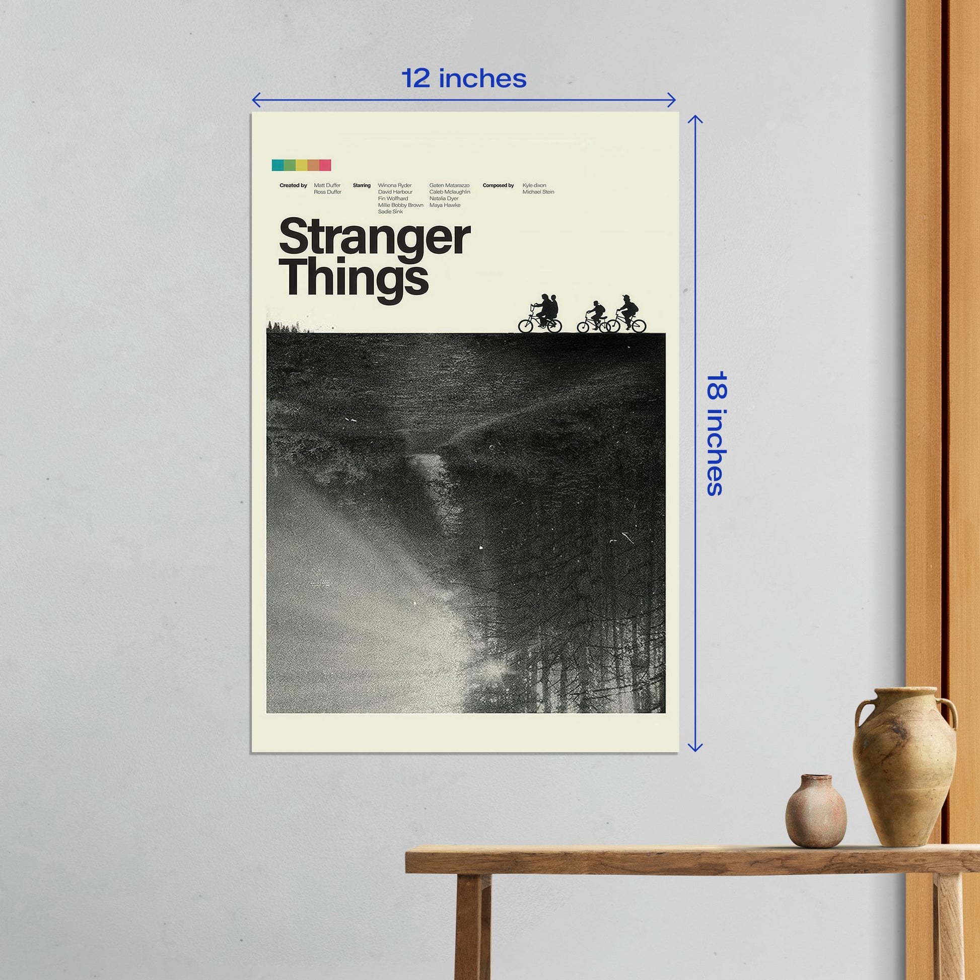Medium 12x18 inch Stranger Things metal poster displayed on a white wall featuring the iconic silhouette of kids on bicycles.