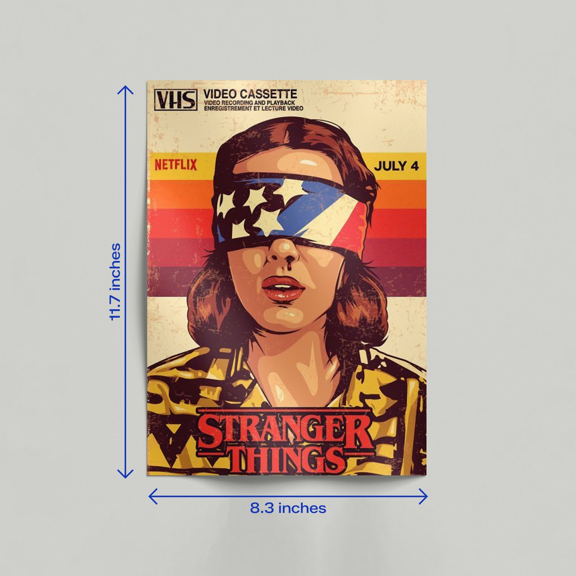 Large vintage VHS style Stranger Things poster featuring Eleven wearing an American flag blindfold with dimensions 16.5 inches height by 11.7 inches width.