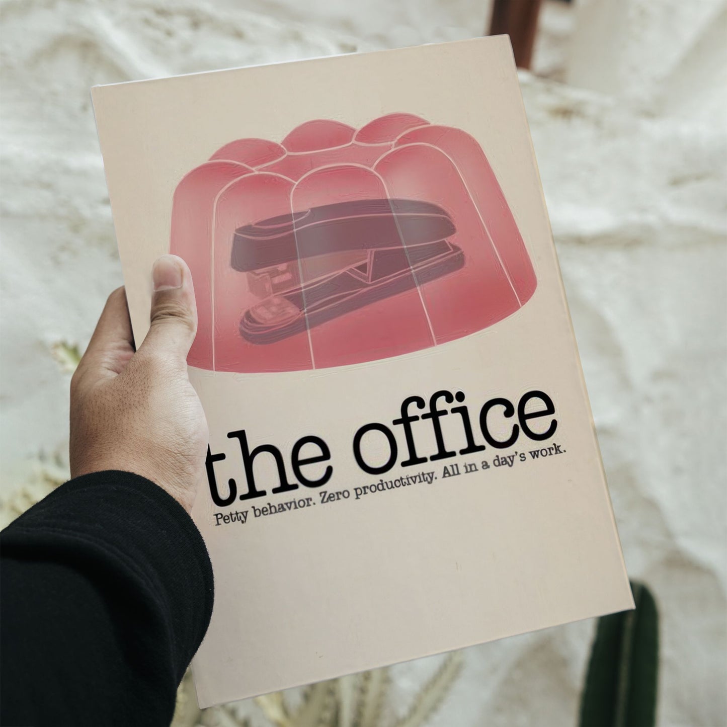 The Office TV show minimalist poster featuring a black stapler encased in pink jello on a 16.5 by 11.7 inch art print.